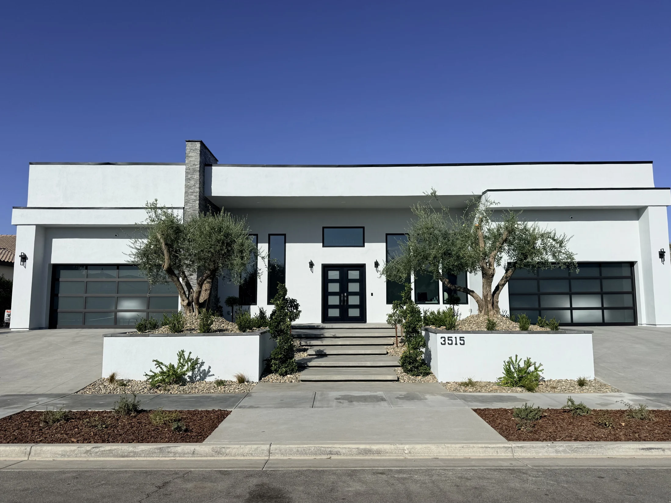 Front exterior of a completed 4,500-square-foot modern home in Belcourt, Bakersfield